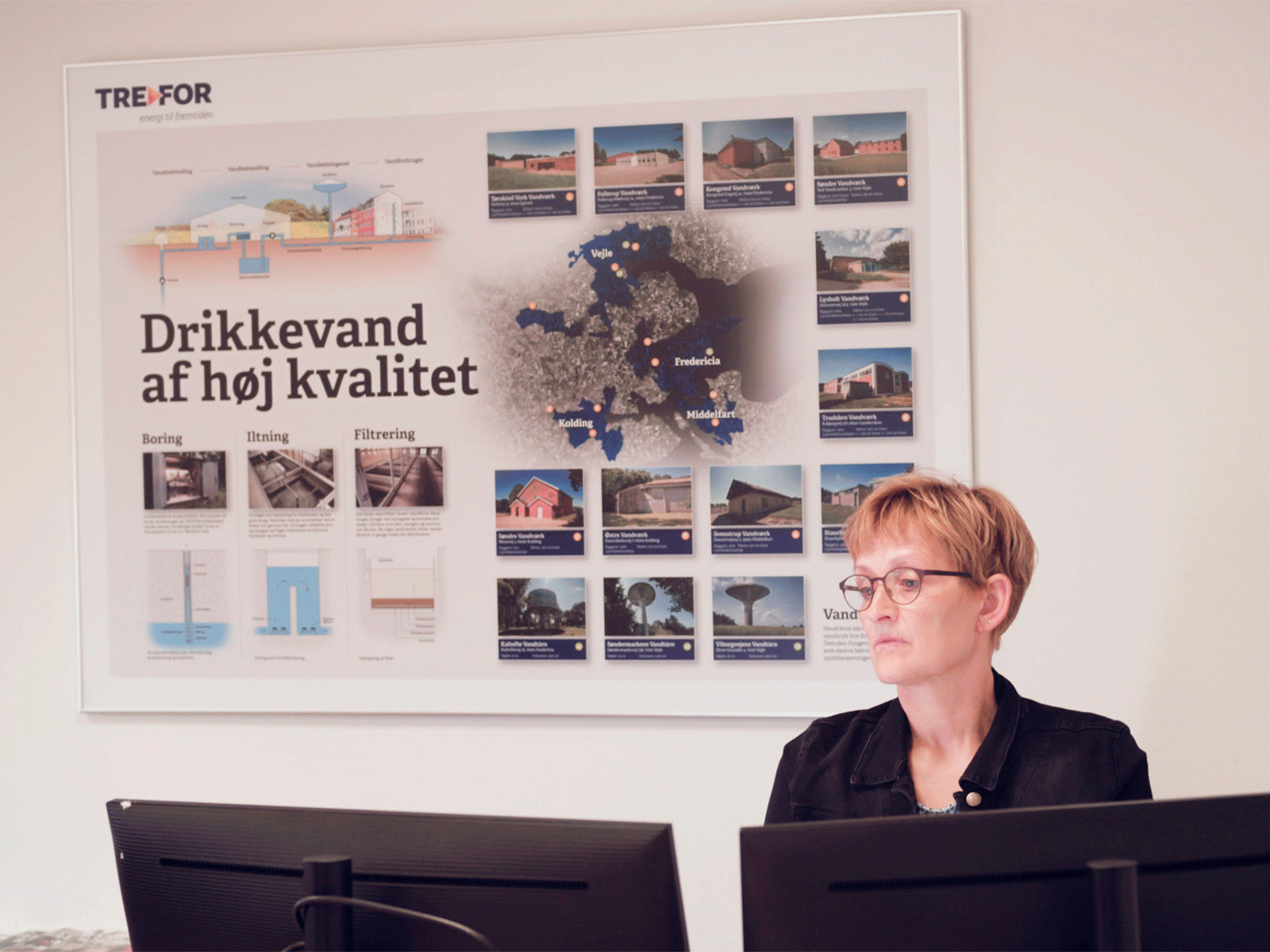 En ingeniør sidder og venter ved sin skærm. 